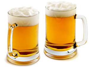 Two mugs of delightful amber beer with the big foam